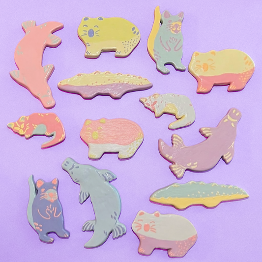 Animal shaped magnets on a pastel purple background