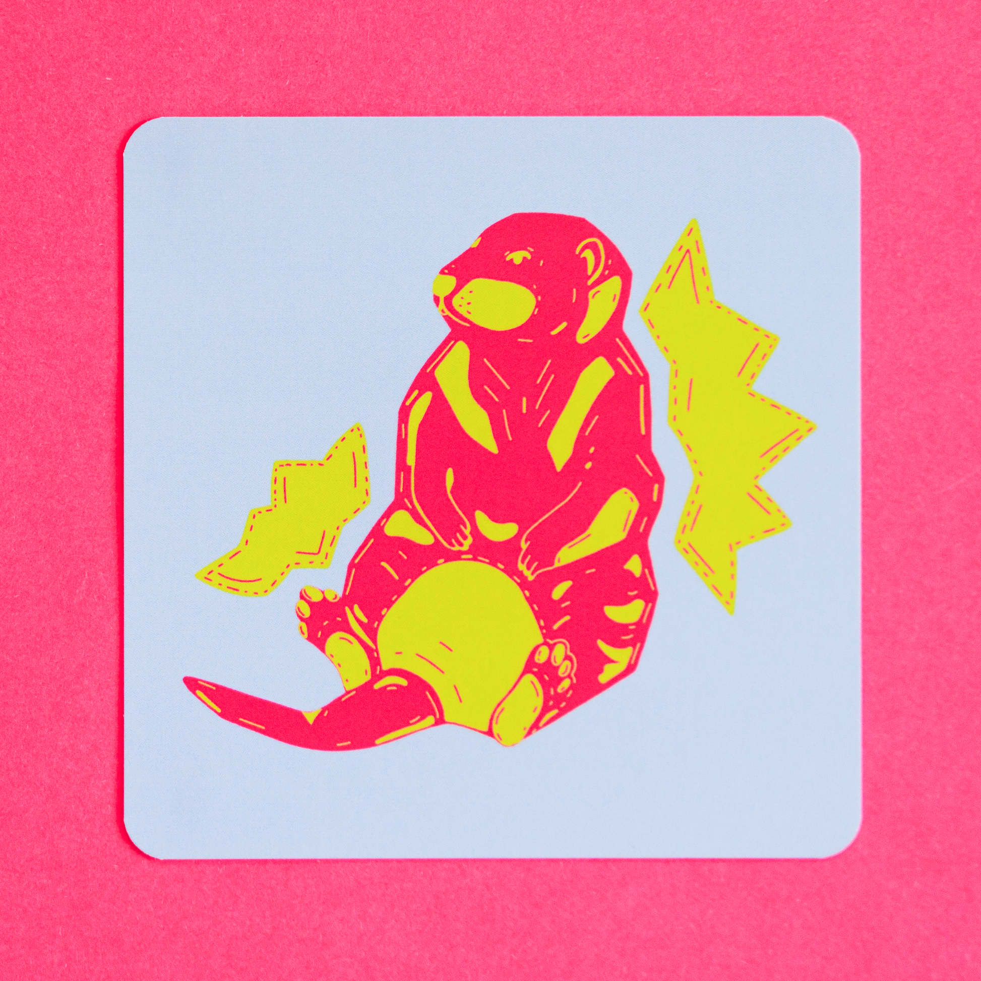 Colourful pink and green otter illustration with a light blue background on a pink framed background